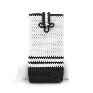 May include: A rectangular crochet phone pouch featuring a white upper section and a solid black base separated by two thin black horizontal stripes. The pouch includes a black and white crocheted tab closure with a decorative knot detail.