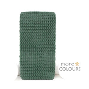 May include: A deep green crocheted rectangular cushion or throw pillow. The cushion is made of a soft, textured yarn and has a simple, modern design.
