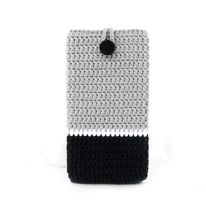 May include: Grey and black crocheted phone case with a white stripe and a black button.