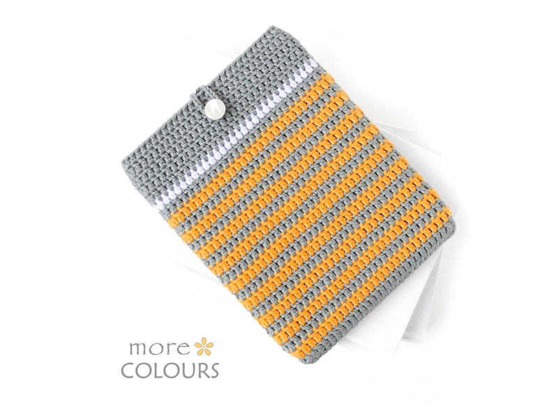 Crocheted e-reader soft case made of Grey durable cotton yarn with Orange stripes and White stripe above them. The e-reader cover closes with a White plastic button and a strong loop.