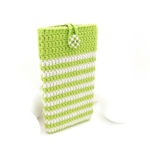 May include: A green and white striped crocheted phone case with a white button.