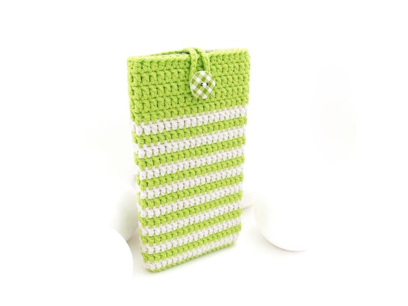 The phone sleeve case is crocheted of high quality mercerized cotton yarn - strong and durable material with a slight natural shine in Apple Green color and Cream rows in rib pattern, closed with a matching checkered button.