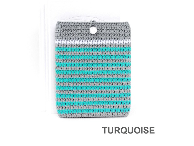 Crocheted e-reader soft case made of Grey durable cotton yarn with Turquoise stripes and White stripe above them. The e-reader cover closes with a White plastic button and a strong loop.