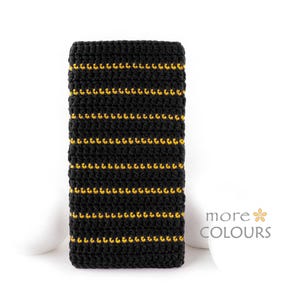 May include: Black crocheted tie with gold stripes.
