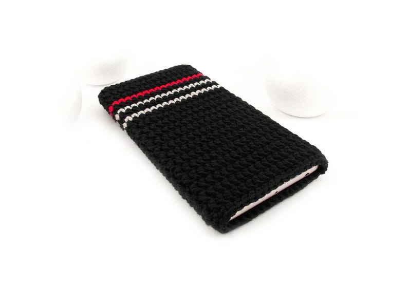 Picture shows a Black phone sock with 3 pinstripes at the bottom - 1 Red and 2 Grey. This eco-friendly phone cover case is crocheted in dense stitch of strong durable mercerized cotton yarn with a slight natural shine.