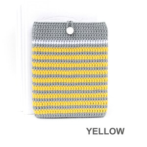 Crocheted e-reader soft case made of Grey durable cotton yarn with Yellow stripes and White stripe above them. The e-reader cover closes with a White plastic button and a strong loop.