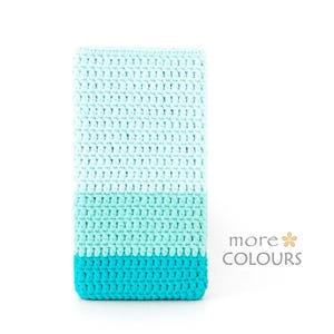 May include: A rectangular crochet sleeve featuring a color-blocked design in three shades of blue, transitioning from a light mint at the top to a medium turquoise in the middle and a vibrant cyan at the base. The text more COLOURS is visible.