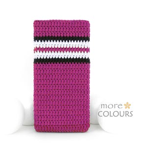 May include: A magenta crochet phone case with a horizontal stripe design in white, black, and pink. The case is rectangular and appears to be handmade. The words "more COLOURS" are printed on the right side of the case.