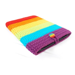 May include: A rainbow striped crochet tablet case with a purple flap and a rainbow button closure.