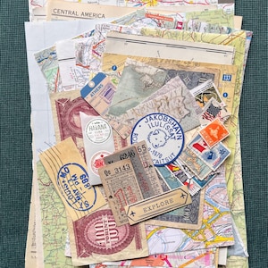 May include: A collection of vintage travel memorabilia, including maps, stamps, tickets, and labels. Destinations include Athens, Havana, and Central America. The word "EXPLORE" is visible on a small tag.