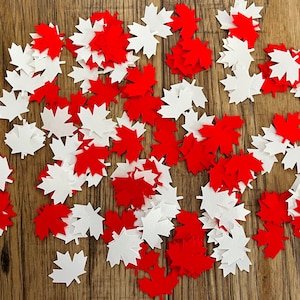 May include: A scattering of red and white maple leaf confetti. The leaves are made of felt and are ideal for decorating for a Canadian themed party or event.