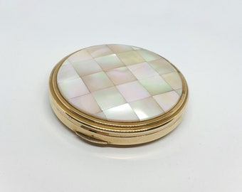 Vintage 1960s Kigu gold tone face powder compact with mother of pearl lid.