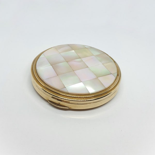 Vintage 1960s Kigu gold tone face powder compact with mother of pearl lid.