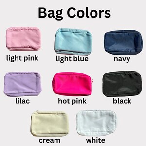 May include: A set of ten different colored cosmetic bags. The bags are all the same size and shape, and they are arranged in two rows of five. The colors of the bags are light pink, light blue, navy, lilac, hot pink, black, cream, white, and two shades of blue.
