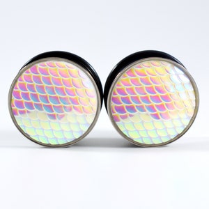 May include: A pair of iridescent mermaid scale ear gauges with a silver rim and black backing.