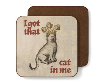 May include: A brown and white coaster with the text "I got that cat in me" and a cartoon image of a cat wearing a crown.