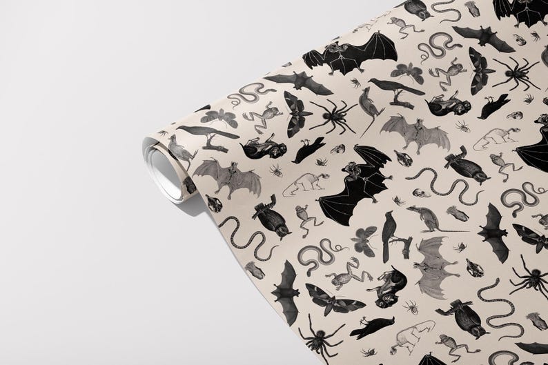 May include: Rolled wallpaper featuring a repeating pattern of black and gray bats, spiders, snakes, frogs, moths, and crows on a beige background. The design has a vintage, Halloween-themed aesthetic.
