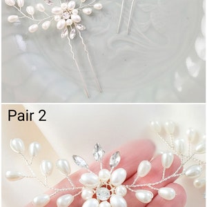 Puede incluir: Un par de horquillas de plata con adornos de perlas y cristales. Cada horquilla presenta un delicado dise&ntilde;o floral con peque&ntilde;as perlas y un cristal m&aacute;s grande en el centro. Las horquillas son perfectas para a&ntilde;adir un toque de brillo a cualquier peinado.