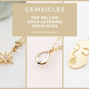 May include: Three gold necklaces with different pendants: a starburst with clear stones, a teardrop-shaped clear stone, and a face outline. The text "GEMSICLES TOP SELLING GOLD LAYERING NECKLACES Gemsicles.Etsy.com" is displayed above the necklaces.