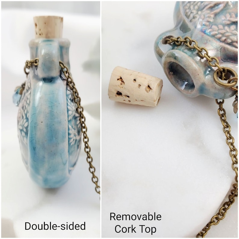 May include: Double-sided, light blue ceramic flask with a removable cork top. The flask has a floral design and a brass chain. The text "Double-sided" and "Removable Cork Top" are visible in the image.