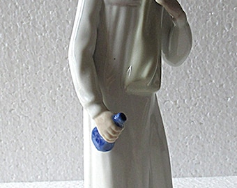 Casades girl with bottle figurine