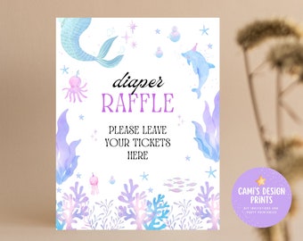 May include: A printable sign with a mermaid, a dolphin, and seaweed. The sign says "diaper raffle" and "Please leave your tickets here".