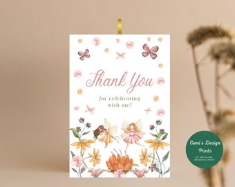 May include: Thank you card with a floral design and two fairies. The card has a pink and white background with butterflies and flowers. The text on the card says "Thank You for celebrating with me!"