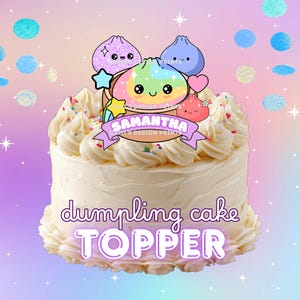 May include: A round cake with white frosting and colorful sprinkles, featuring a decorative topper with cartoon dumplings, a pink heart, and a banner displaying the name SAMANTHA. The text below reads dumpling cake TOPPER.