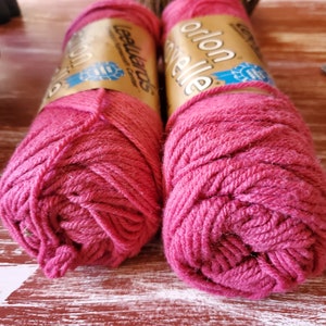 May include: Two skeins of red yarn, one labeled "LeeWards Cottonelle" and the other labeled "Orlon".