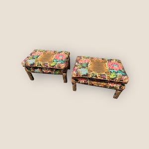 May include: Two matching tiger print ottomans with floral accents. The ottomans have a dark brown base and four legs.