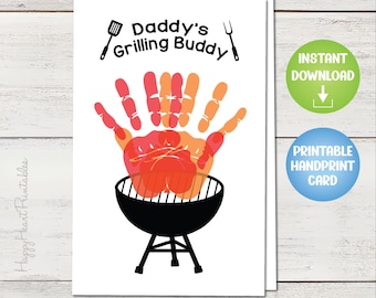 May include: A white card with the text "Daddy's Grilling Buddy" and a handprint design in red and orange, above a black grill illustration. Includes "Instant Download" and "Printable Handprint Card" buttons.