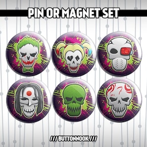 May include: A set of six circular pins or magnets, each displaying a skull design with different character themes. The pins have a purple backdrop with green and pink splatter effects. The text "PIN OR MAGNET SET" is at the top.