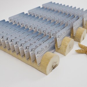 May include: A display of business cards in a wooden holder, with a starfish. The cards have a blue and white design with the text "Seallin' the Beach". The holder is made of light-colored wood, and the starfish is tan.