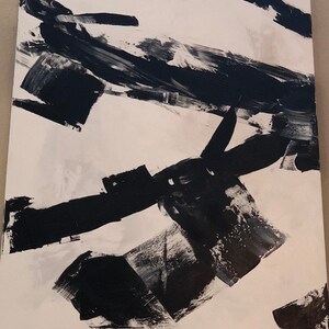 May include: Abstract black and white painting with bold brushstrokes on a white canvas.