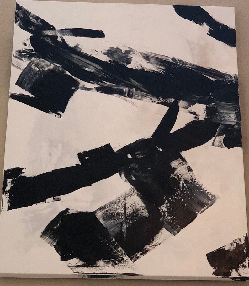 May include: Abstract black and white painting with bold brushstrokes on a white canvas.