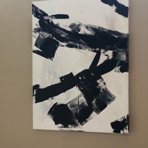 May include: Abstract painting with black and white brushstrokes on a white canvas.