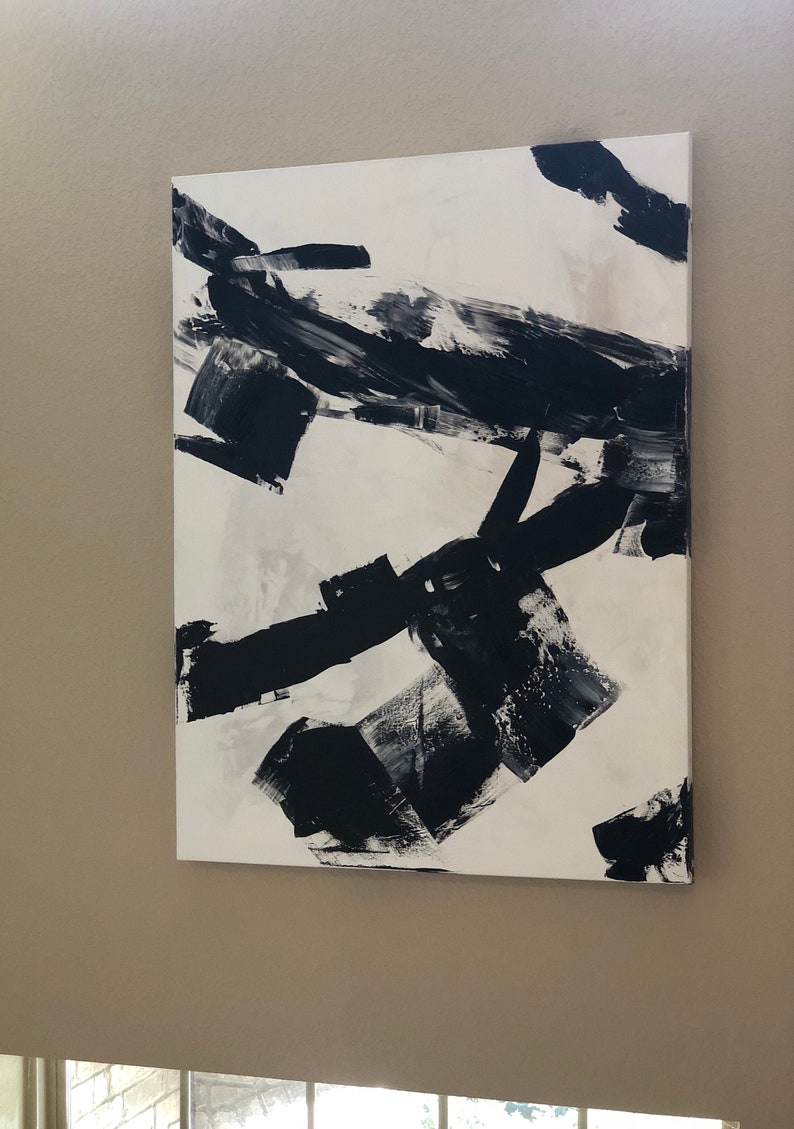 May include: Abstract painting with black and white brushstrokes on a white canvas.