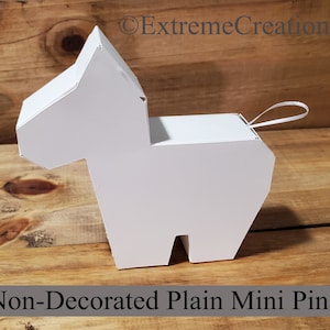 May include: A white, undecorated mini pinata shaped like a donkey. It has a small loop at the top for hanging.