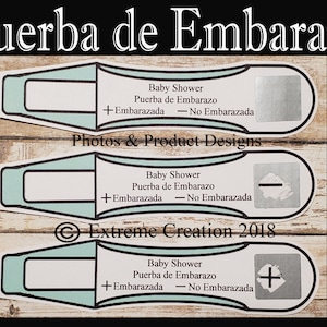 May include: Three light blue and white pregnancy test-style cards with the text "Baby Shower Puerba de Embarazo +Embarazada -No Embarazada" and a silver circle with a plus or minus sign in the center. The text "Photos & Product Designs" and "Extreme Creation 2018" are also visible.