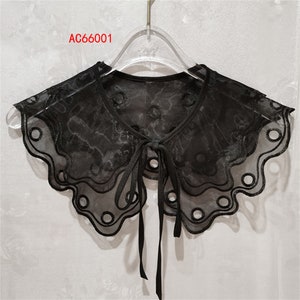 May include: Black sheer lace collar with a scalloped edge and a bow tie. The collar has a delicate floral pattern and small round cutouts. The text "AC66001" is visible in the top left corner of the image.