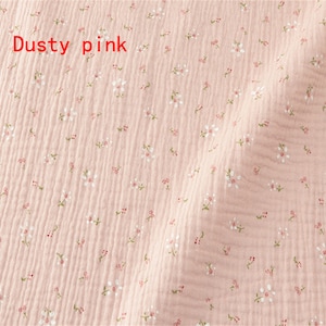 May include: Dusty pink fabric with a small white floral pattern.