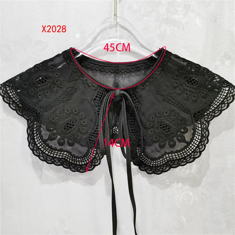 May include: Black lace collar with a bow tie, measuring 45 cm wide and 14 cm long. X2028.