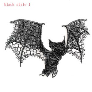 May include: A black lace bat applique with detailed wings and body. The text "black style 1" is in the upper left corner. Ideal for adding a gothic touch to clothing or craft projects. The lace has a delicate, open weave.