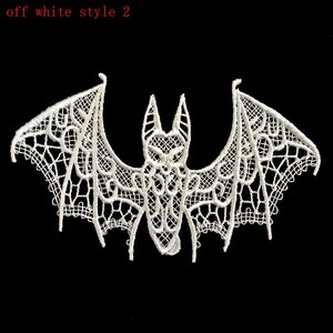 May include: Off-white lace bat with an elaborate openwork pattern. The bat features extended wings and a detailed body, suitable for Halloween or gothic crafts. The text "off white style 2" is in the upper left corner.