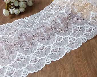 May include: White lace trim with a scalloped edge and a delicate floral pattern.