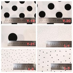 May include: A collection of six white fabrics featuring black polka dot patterns of varying sizes, labeled Y-19, Y-20, Y-21, L-1, L-2, and L-3. Each fabric sample is displayed with a metal ruler showing measurements in centimeters for scale.