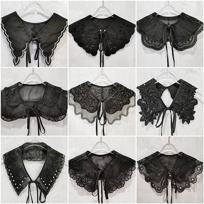 May include: Nine black lace collars with different designs, including scalloped edges, floral patterns, and beaded embellishments. Each collar has a ribbon tie at the back.