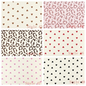May include: A collection of six fabric swatches featuring repeating patterns. Style 43 has brown hearts on cream, 44 has pink leopard print, 45 has brown leopard print, 46 has red hearts on cream, 47 has pink hearts on cream, and 48 has black hearts on cream.