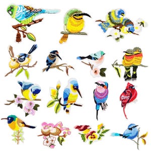 May include: A collection of fifteen embroidered bird patches featuring various species in vibrant colors including blue, yellow, red, and green. Each patch depicts a bird perched on a branch, some accompanied by flowers or leaves, with detailed stitching.