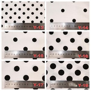 May include: A collection of six white fabric swatches featuring black polka dots of varying sizes, each labeled with a red code from Y-13 to Y-18 and displayed with a metal ruler showing measurements in centimeters up to 15 cm.